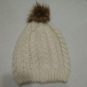 Ivory cable stitch hat with faux fur pom pom beanie